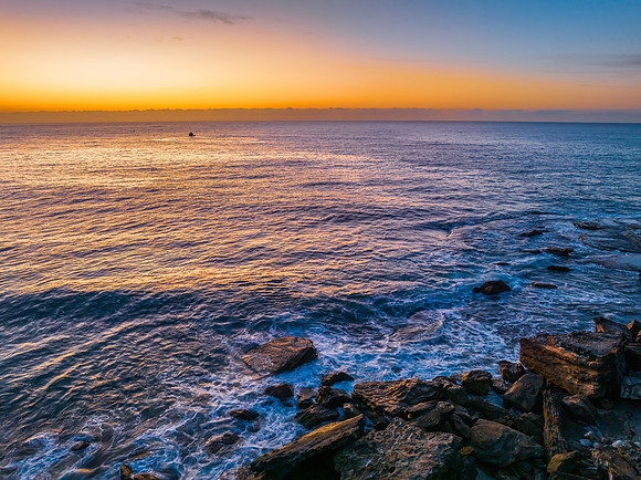 Pretty blue sunrise at the beach with calm seas