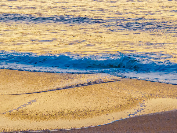 The blue sea during sunrise at the beach with calm seas