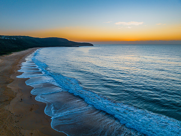 Pretty blue sunrise at the beach with calm seas