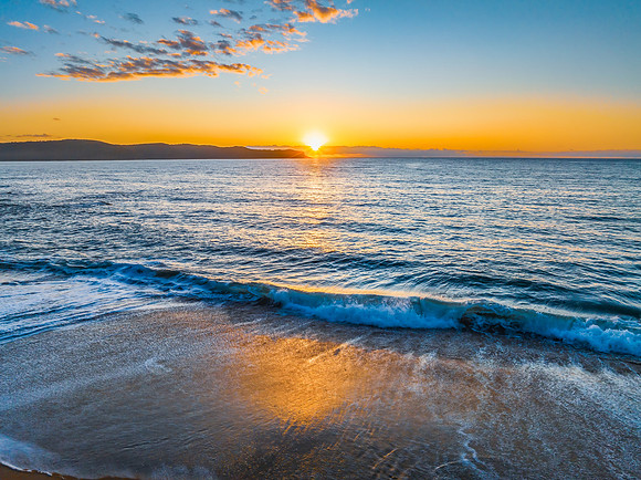 Aerial sunrise views over the ocean and beach