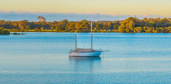 Sunrise panorama over the river with a boat