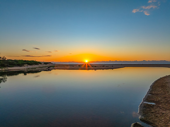 Summer sunrise at the seaside lagoon