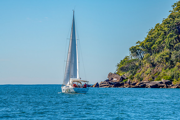 The blue sea and a yacht sailing on Broken Bay