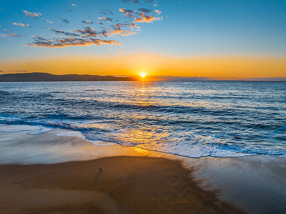 Aerial sunrise views over the ocean and beach