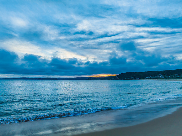 High cloud sunset over the sea and beach