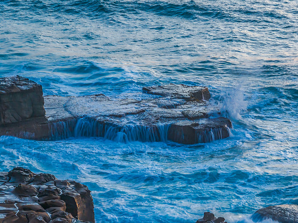 Top down sunrise over the sea and rock platform