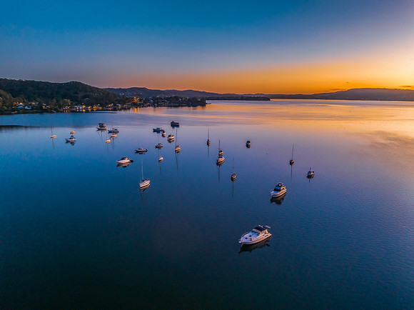 Aerial sunrise waterscape with boats