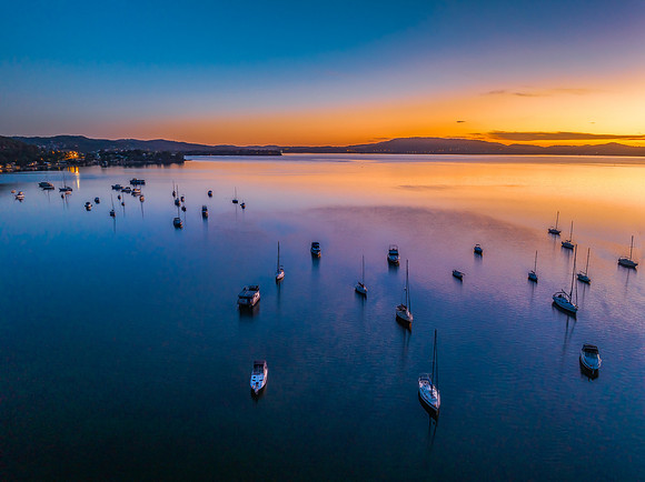 Aerial sunrise waterscape with boats