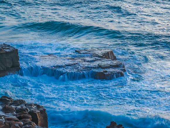 Top down sunrise over the sea and rock platform