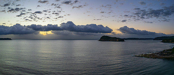 Aerial sunrise seascape panorama with clouds
