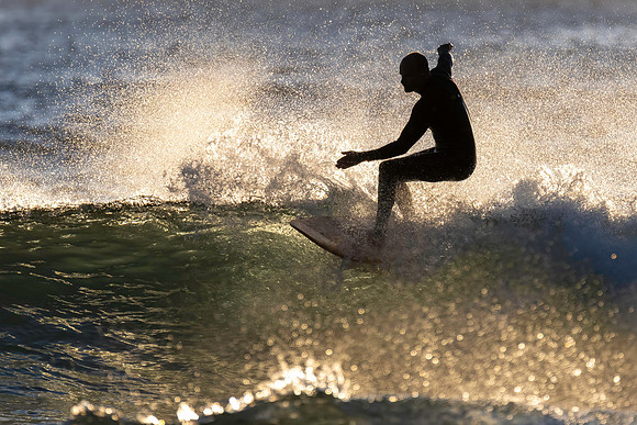 Surfers and Sunrise at the seaside