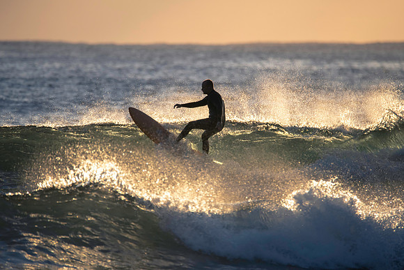 Surfers and Sunrise at the seaside