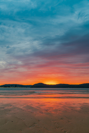 Colourful cloud filled sunrise at the seaside