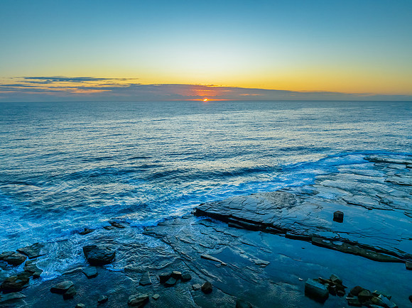 Sunrise blues over the sea and rocky Inlet