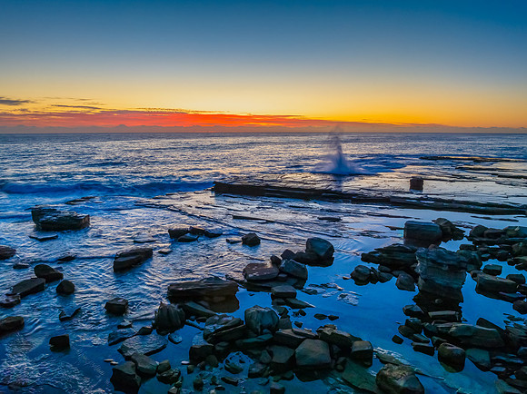Sunrise blues over the sea and rocky Inlet