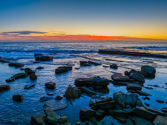 Sunrise blues over the sea and rocky Inlet