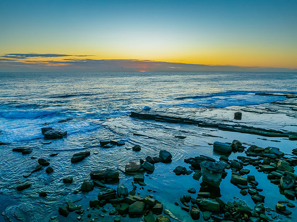 Sunrise blues over the sea and rocky Inlet