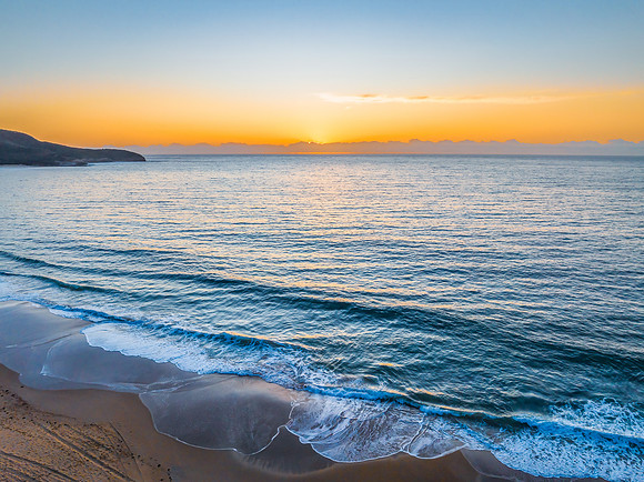 Sunrise at the seaside with orange horizon