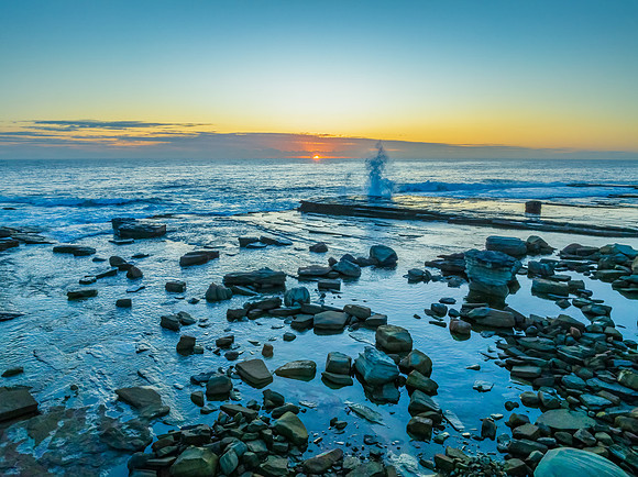 Sunrise blues over the sea and rocky Inlet