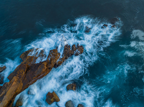 Blue hour, rocks and the sea