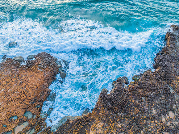 Top down sunrise over the sea and rock platform