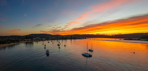 Sunrise panorama waterscape over the channel with boats