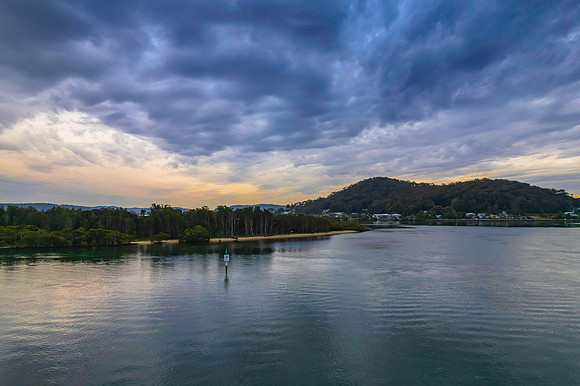 Cloud covered aerial sunrise waterscape