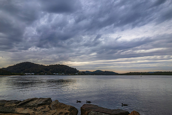 Cloud covered aerial sunrise waterscape