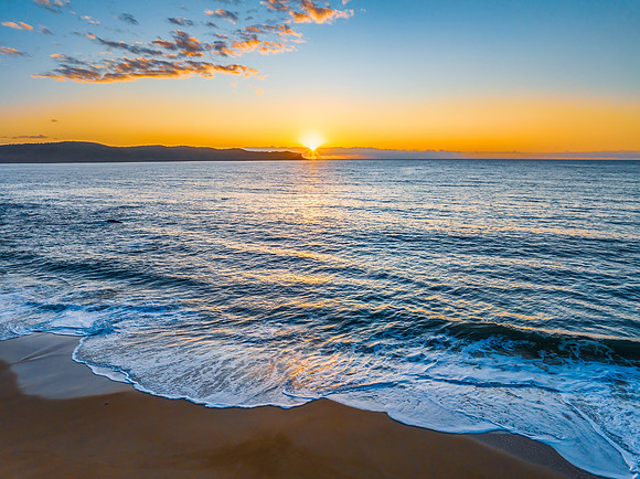 Aerial sunrise views over the ocean and beach