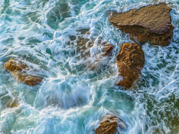 Rocks and sea action in the early morning light