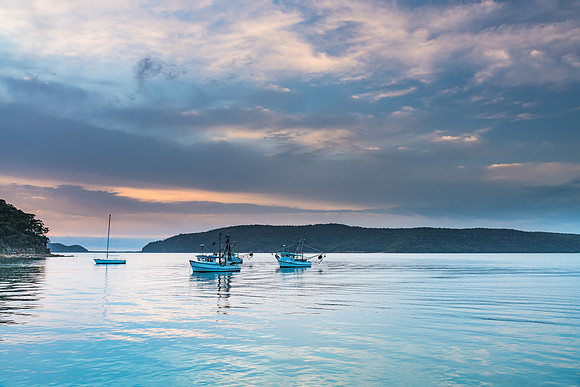 Serene Morning Waterscape with Soft Clouds over the Bay