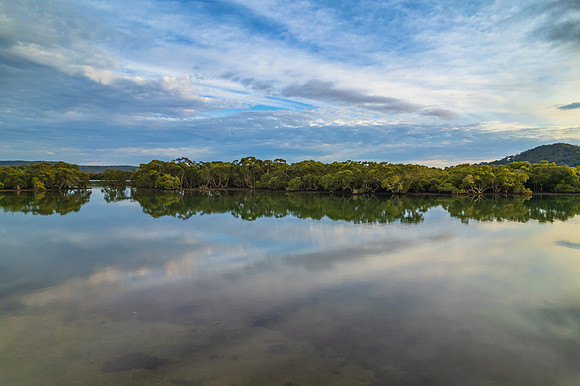Clouds and reflections early morning waterscape