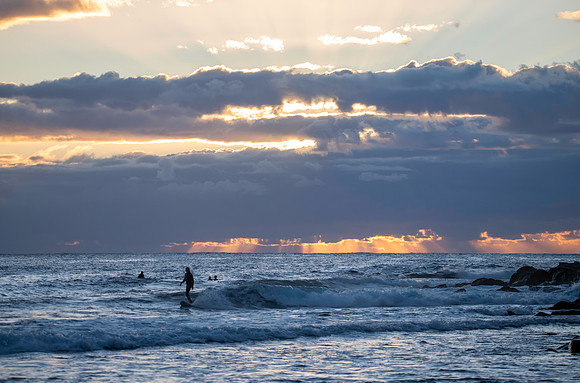 Surfers and Sunrise at the seaside