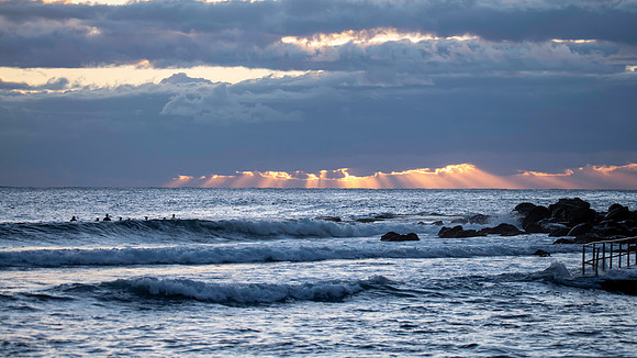 Surfers and Sunrise at the seaside