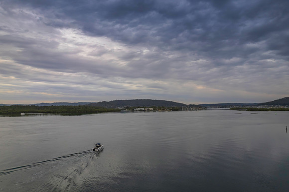 Cloud covered aerial sunrise waterscape