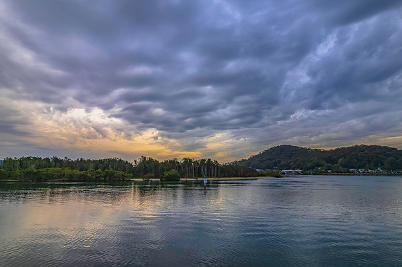 Cloud covered aerial sunrise waterscape
