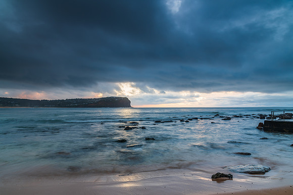 Cloud covered sunrise at the seaside