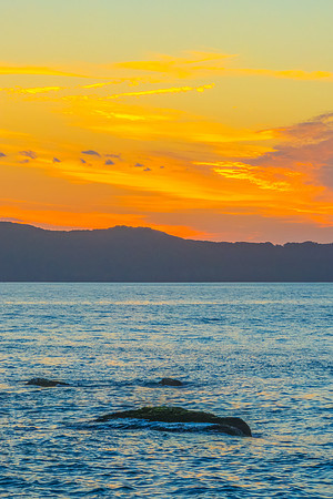 Aerial sunrise at the seaside with light scattered high cloud an