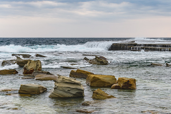 Moody and Overcast Rocky Sunrise Seascape
