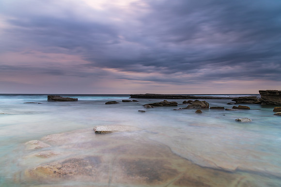 Moody and Overcast Rocky Sunrise Seascape