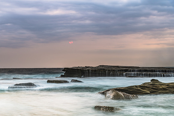 Moody and Overcast Rocky Sunrise Seascape