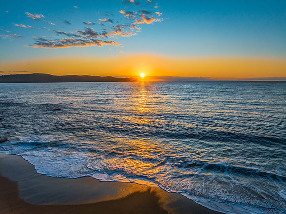 Aerial sunrise views over the ocean and beach