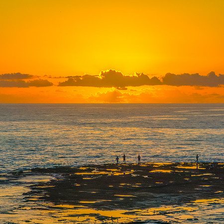 Sunrise over the sea and rocks with clear skies