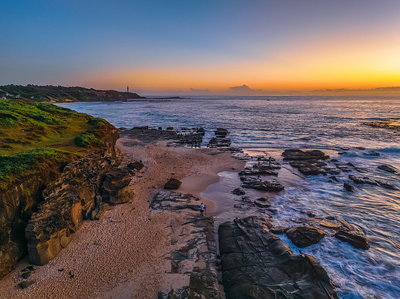 Sunrise over the sea and rocks with clear skies