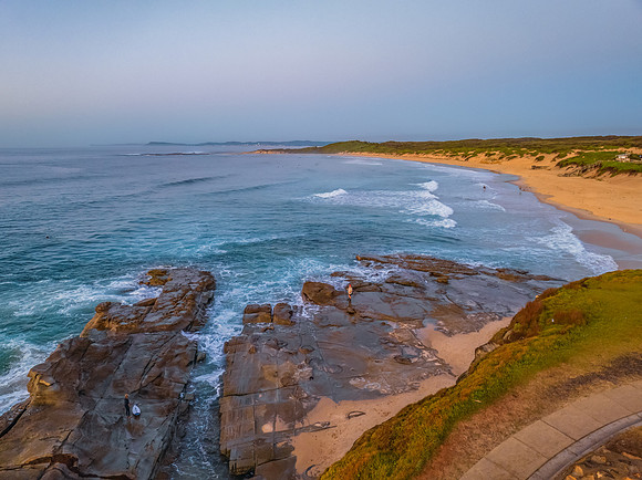 Sunrise over the sea and rocks with clear skies