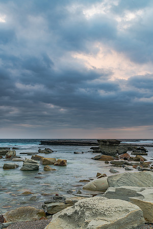 Moody and Overcast Rocky Sunrise Seascape