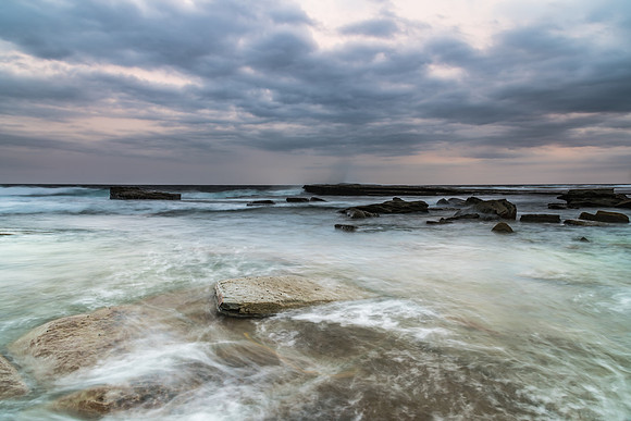 Moody and Overcast Rocky Sunrise Seascape