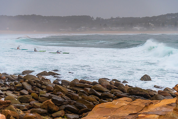 Early Morning Kayakers heading out into rough seas