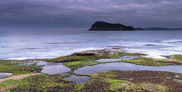 Cloudy Sunrise Seascape with Island and Green Mossy Rock Ledge