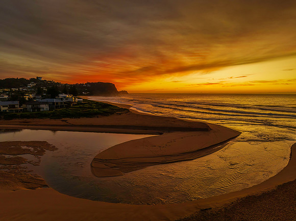Sunrise and high cloud cover by the sea and lagoon